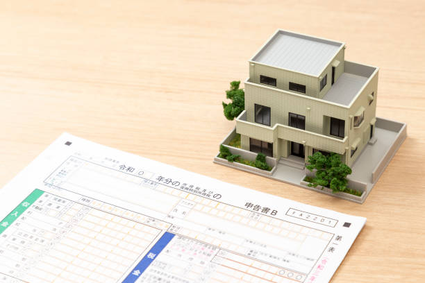 istock Tax return documents and a model house on a desk. 2193115270