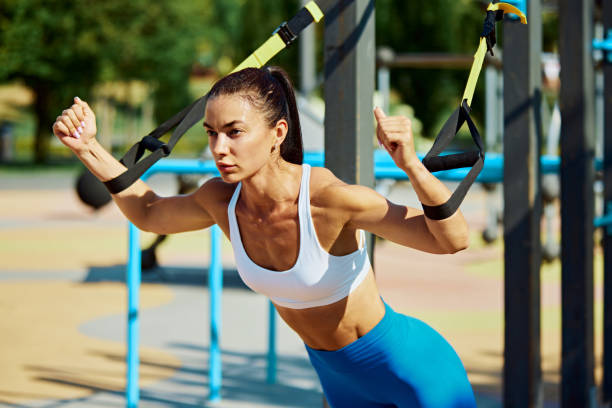 istock Woman executes exercise, her body leaning forward, arms extended. Athlete fully engaged in workout. Gym outdoor. 2193115655