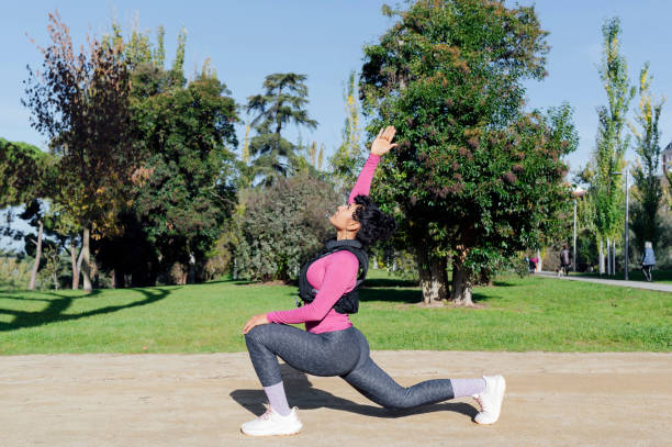 istock Young woman doing a stretch with a vest in a park. 2193116983