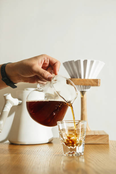 istock Crafting Perfect Cup of Coffee With V60 Pour-Over Method in Cozy Kitchen Setting During the Morning Sunlight Against White Wall 2193117475