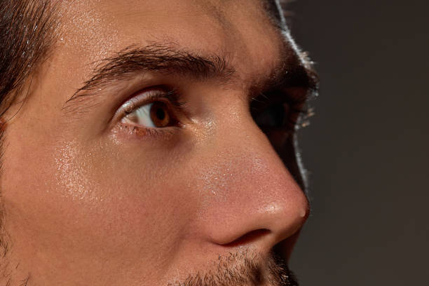 istock Detailed shot of man's eye, capturing sharp lashes and smooth skin texture. Lighting enhances natural details and subtle glow on face. 2193118077