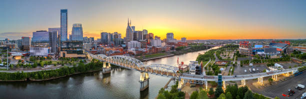 Nashville, Tennessee, USA skyline over the Cumberland River Nashville, Tennessee, USA skyline over the Cumberland River at sunset. nashville tennessee bridge stock pictures, royalty-free photos & images
