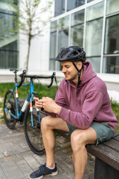 istock Mid adult man using phone after riding a bike 2193120534