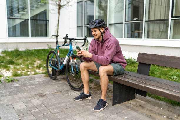 istock Mid adult man using phone after riding a bike 2193120562
