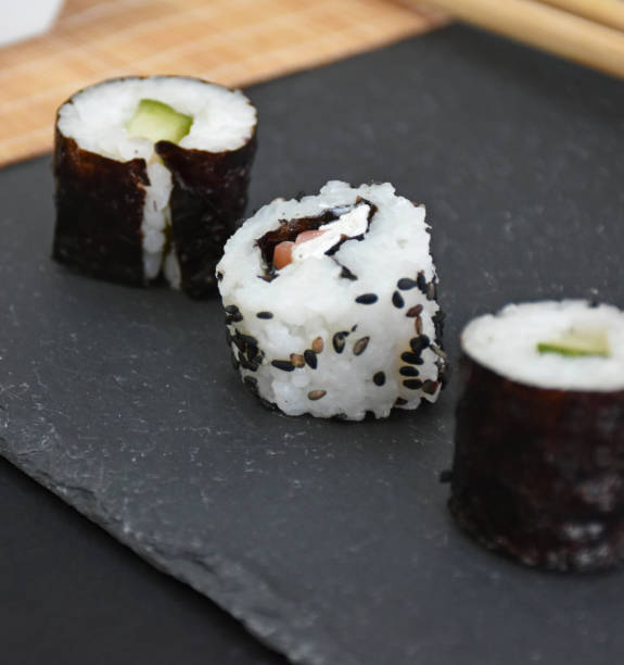 Japanese style table setting with three pieces of sushi close up