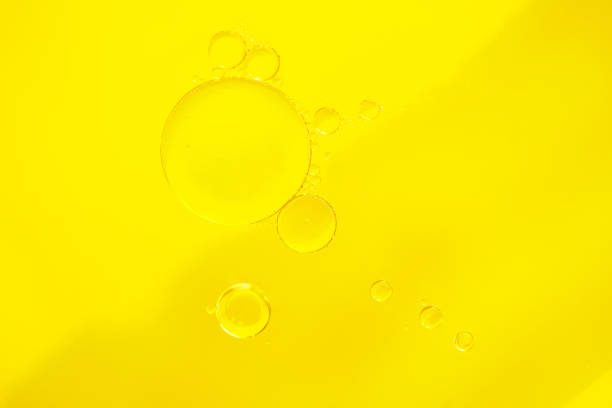 istock Abstract Bubbles oil on Bright Yellow Background. Macro photo 2193123599