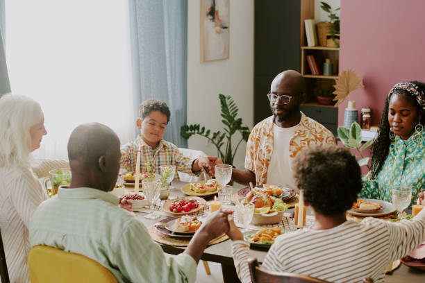 istock Family Praying at Table Together 2193125976