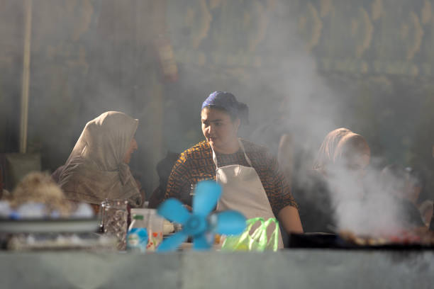 Tashkent, Uzbekistan, October 4 2024: unidentified worker makes the food in food court at Chorus Bazaar.  Chorus Bazaar is one of famous landmark in Uzbekistan