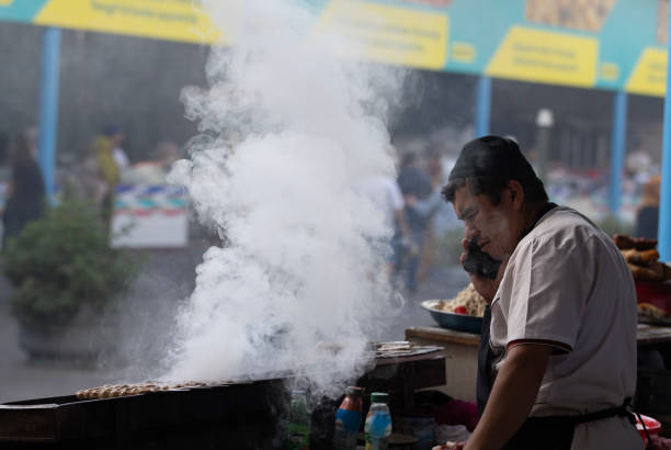 Tashkent, Uzbekistan, October 4 2024: unidentified worker makes the food in food court at Chorus Bazaar.  Chorus Bazaar is one of famous landmark in Uzbekistan