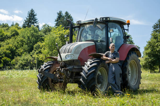 istock Farmer on a tractor in the meadow 2193128504