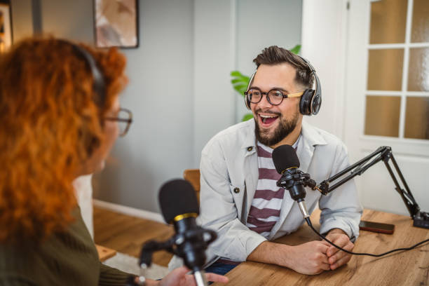 istock two radio hosts smile and enjoy while record podcast in studio 2193128757