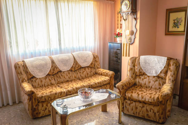 istock Comfortable patterned sofa and armchair  in a 1980s living room 2193130969