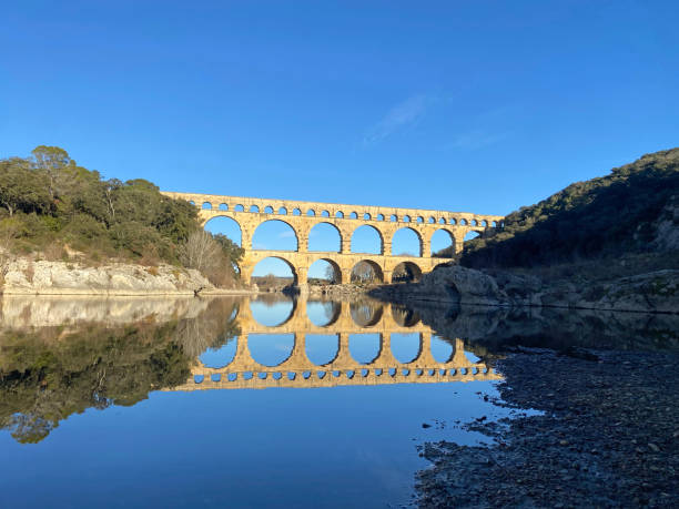 Pont du Gard reflecting in the river