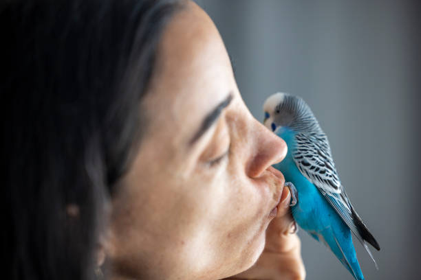 istock woman kissing the bird 2193132226