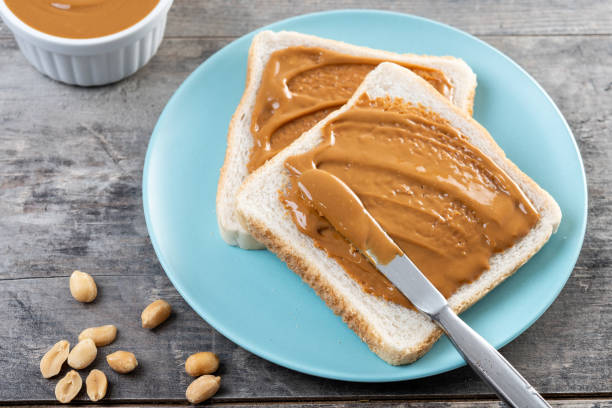 istock Bread toast with peanut butter cream on wooden table 2193135184