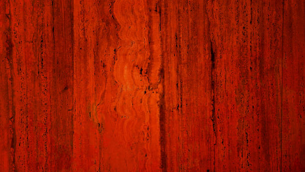 abstract textured travertine stone wall with a red background, ideal for creating a classic and elegant ambiance in design projects.