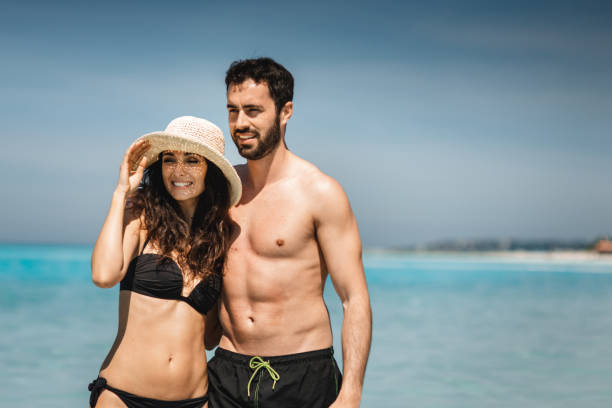 istock happiness couple walking on the beach 2193138185