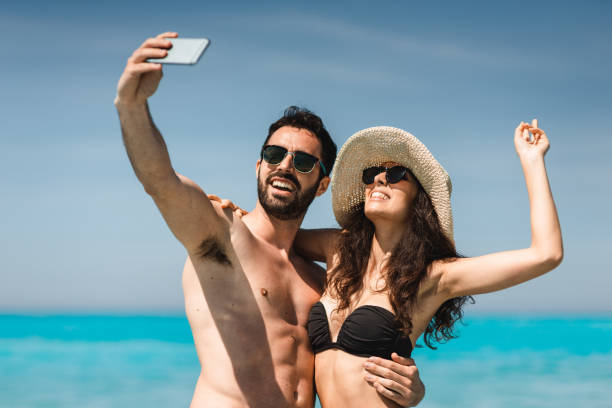 istock couple take a selfie on the beach in summer 2193138372