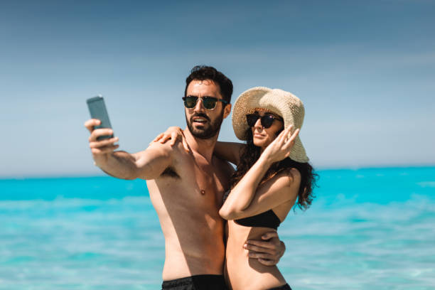 istock couple take a selfie on the beach in summer 2193138453