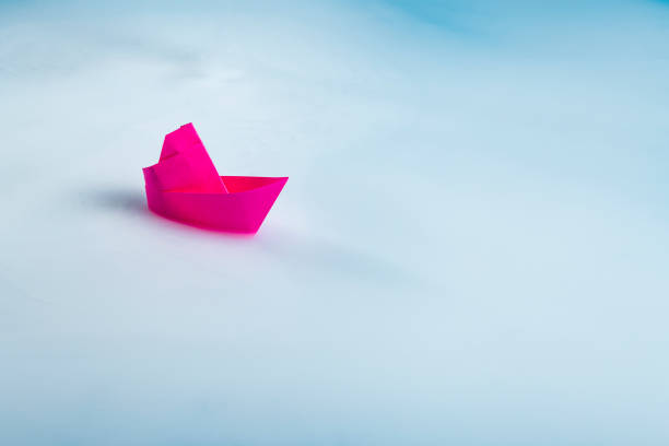 istock A lonely red boat on a blue foggy background 2193138721