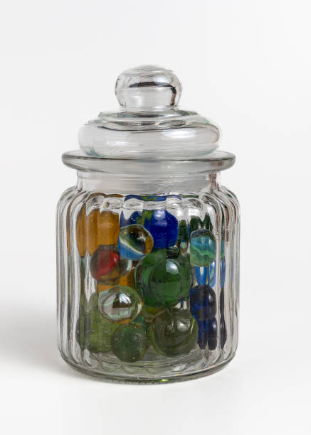istock Multicolored marbles in a glass jar on a white background. 2193140341