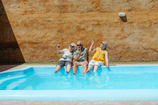 istock Happy Seniors Relaxing By the Pool on a Sunny Summer Day 2193140682