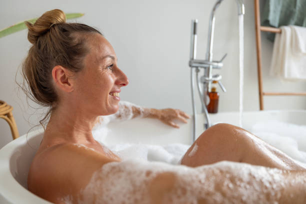 istock Relaxed Woman Enjoying a Bubble Bath in Modern Bathroom 2193142023