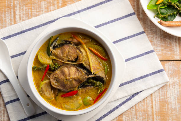 istock Thai Green Curry Catfish,Sliced catfish with green curry paste in coconut milk soup in white bowl.(kaeng kiew waan ikan keli). 2193144766