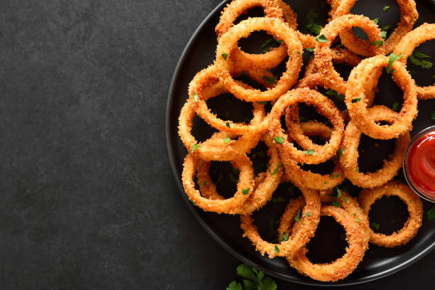 istock Onion rings with tomato sauce on plate 2193145359