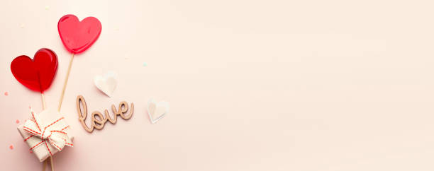 istock Heart shaped lolipops, gift box and love word top view empty copy space horizontal banner, valentine's background,valentines card, romantic banner, flat lay objects. 2193147722
