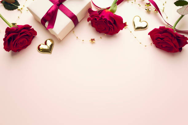 istock Pink Valentine's background empty copy space. Red roses and gift box top view backdrop.Mother's day card. 2193147723