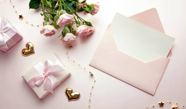 istock Envelope with empty sheet top view decorated with gift boxes and flowers. Greeting, invitation  blank.Valentine card.Mother's day. 2193148358