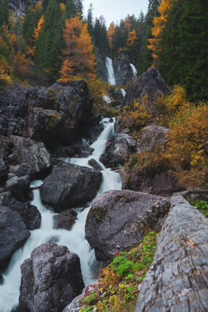 Waterfalls in autumn forest, Dolomites