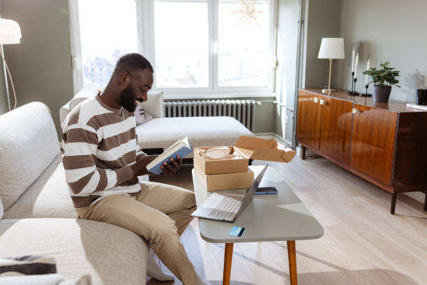 istock African American man unboxing a book from a delivery package 2193152441