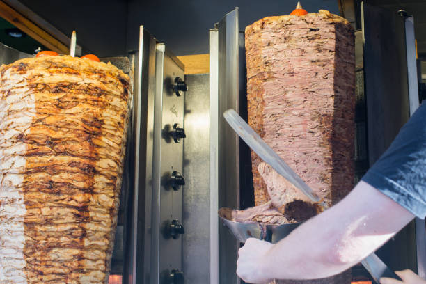 istock Unrecognizable person cooking turkish kebap or kebab on a rotating grill 2193158757