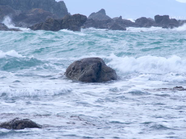 istock Turbulent sea with waves hitting the rocks on the coast. 2193159373
