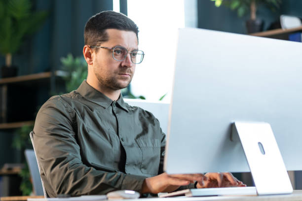 istock Confident businessman working on line with a computer at office near a window with natural light 2193161330