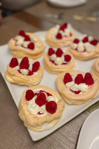 Pavlova mini cakes - meringue dessert with raspberries