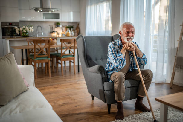 istock Elderly man in an armchair, supported by his walking cane 2193165555