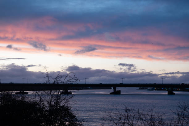 istock Sunset Glow Over Riverside Bridge with Pink Sky 2193167273