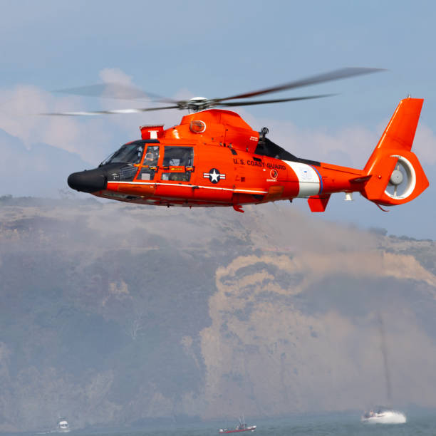 istock Eurocopter MH-65 Dolphin hovering over the sea 2193169287