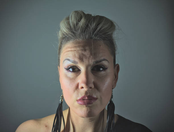 Smiling woman with creative hairstyle and makeup on black background