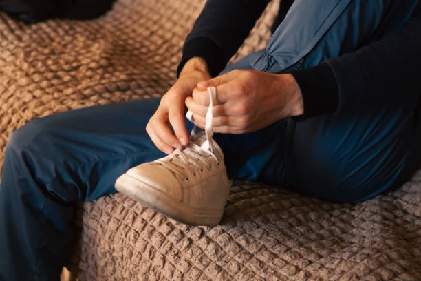istock man tying his shoelace in his shoes 2193171193