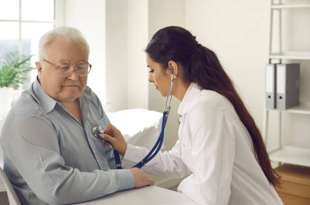 istock Doctor checking retired gentleman lungs with stethoscope at hospital ward 2193171846