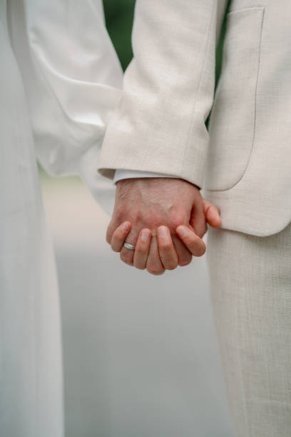 istock The bride and groom are holding hands tightly in white 2193174222