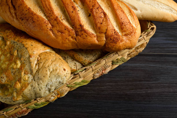 istock Basket with rustic spiced breads on wooden table. Dark background 2193174847