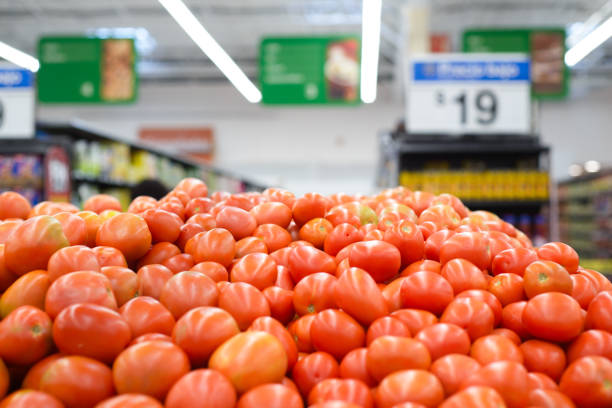 Red tomato shelf in a supermarket. stock photo
