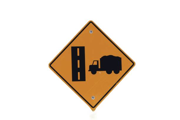 A yellow, diamond shaped, traffic sign with a picture of a truck and a dotted line highway. Sign indicates trucks crossing ahead.