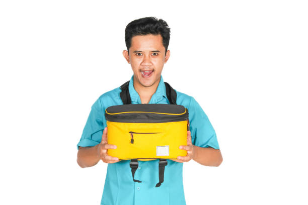 istock Asian man carrying yellow bag showing happy expression isolated on white background 2193176649