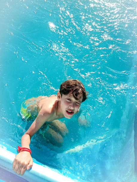 Boy at swimming pool on sunny day
